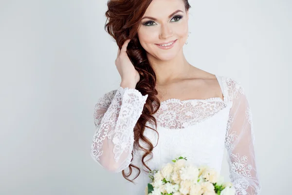 Portret van gelukkige bruid in trouwjurk, witte achtergrond — Stockfoto