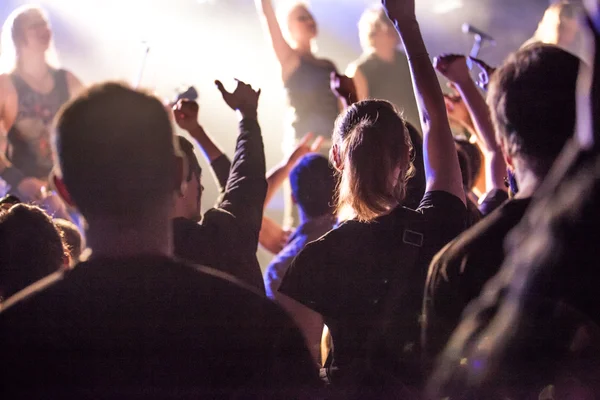 Grunge style photo, people hands raised up on musical concert — Stock Photo, Image