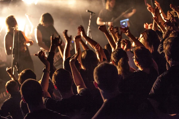 Grunge style photo, people hands raised up on musical concert Stock Image