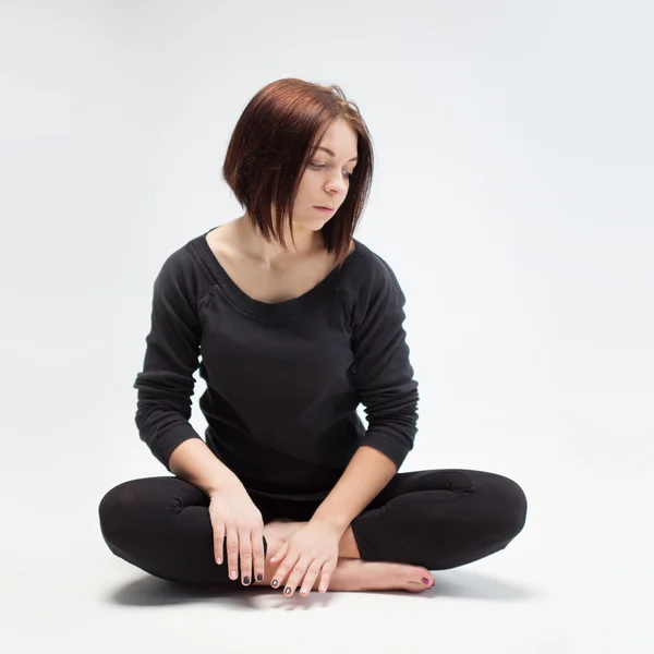 Young beautiful woman sitting in lotus position, closeup — Stock Photo, Image
