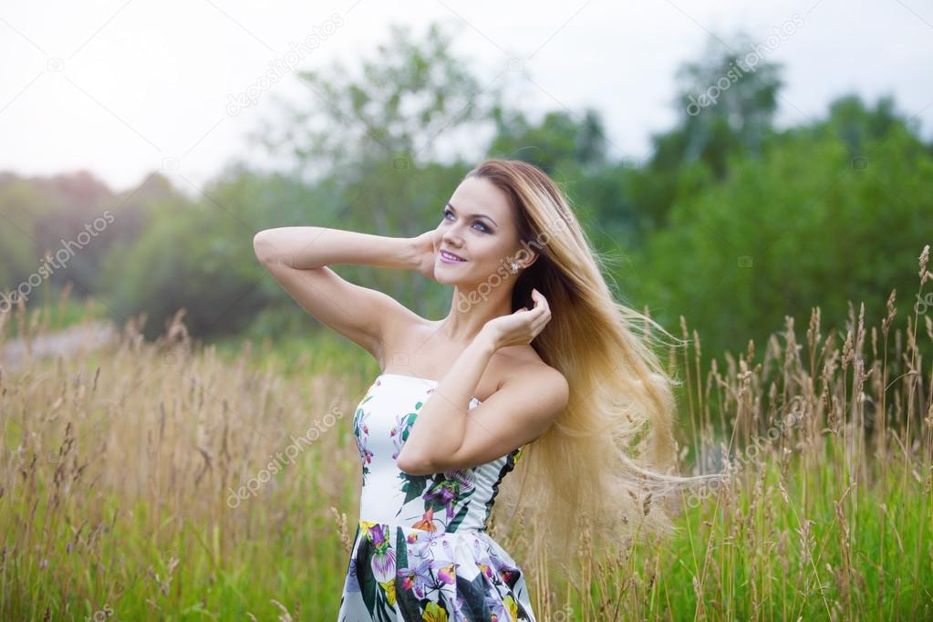   blond girl in dress  on a meadow