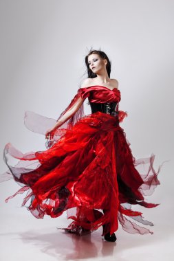 Kırmızı elbiseli genç muhteşem kadın moda fotoğrafı. Stüdyo portre