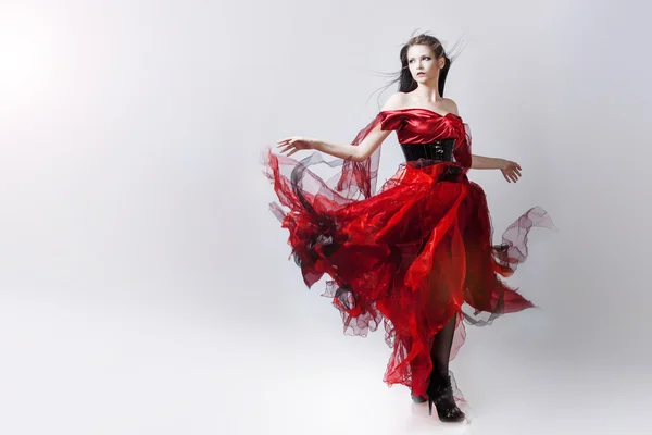 Fashion photo of young magnificent woman in red dress. Studio portrait — Stock Photo, Image