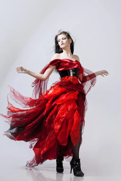 Fashion photo of young magnificent woman in red dress. Studio portrait — Stock Photo, Image