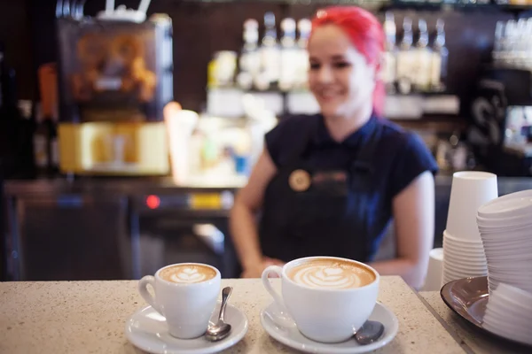 Happy girl Barista gives coffee  to the customers — Stock Photo, Image