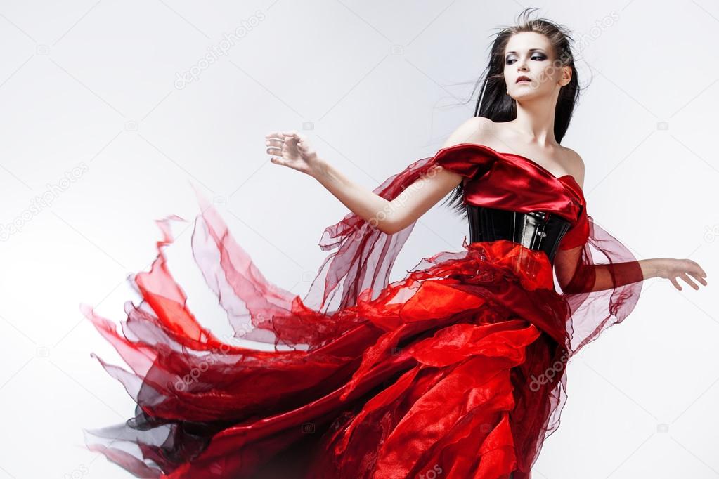 Fashion photo of young magnificent woman in red dress. Studio portrait ...