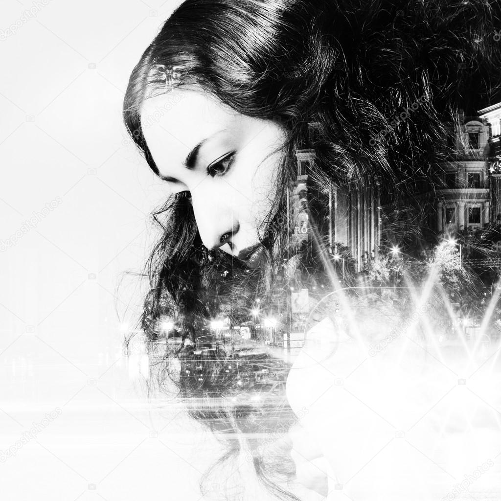 Double exposure of beautiful girl and  city lights at night, black and white toning