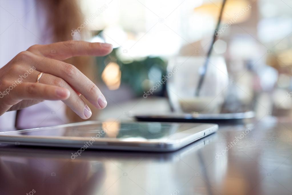 girl works on the digital tablet, a small depth of field, soft focus