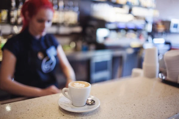 Happy girl Barista gives coffee  to the customers — Stock Photo, Image