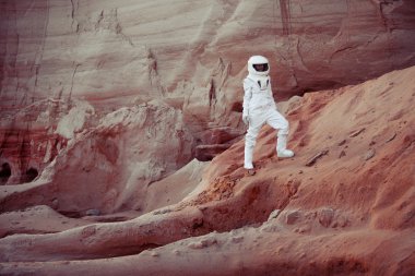 futuristic astronaut on another planet, image with the effect of toning clipart