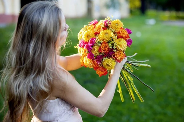 Młoda kobieta piękny kwiaciarni. Dziewczyna w parku rysuje bukiet. Odkryty — Zdjęcie stockowe