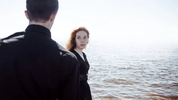 Hermosa pareja joven abrazándose de pie en el mar, efectos de coloración de la foto — Foto de Stock