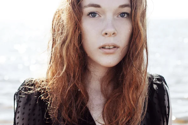 바다의 배경에 빨강 머리 젊은 여자 야외 초상화. 부드러운 밝은 색상. — 스톡 사진