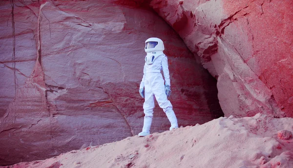 Futuristic astronaut on crazy pink planet, image with the effect of toning — Stock Photo, Image