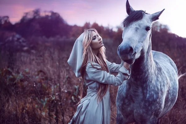 Belleza rubia con caballo en el campo, efecto de tonificación — Foto de Stock