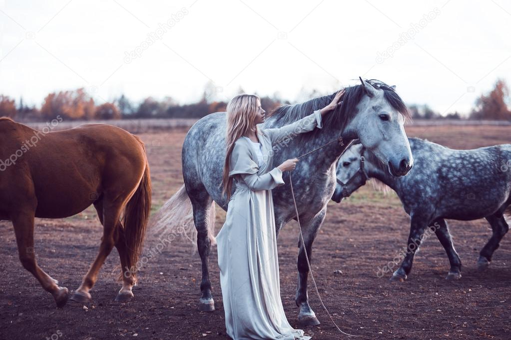 beauty blondie with horse in the field,  effect of toning