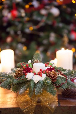 Fir branches decorated for the new year on dark wooden background. Christmas tree and candles, festive mood