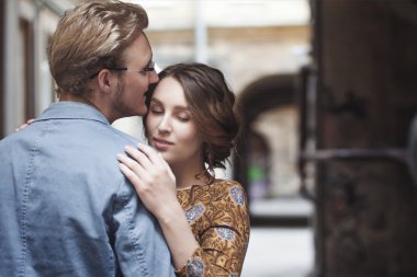 Genç çift aşık açık. Adam, kadın hugs. Bir ortak omzunun üzerinden görünüyor