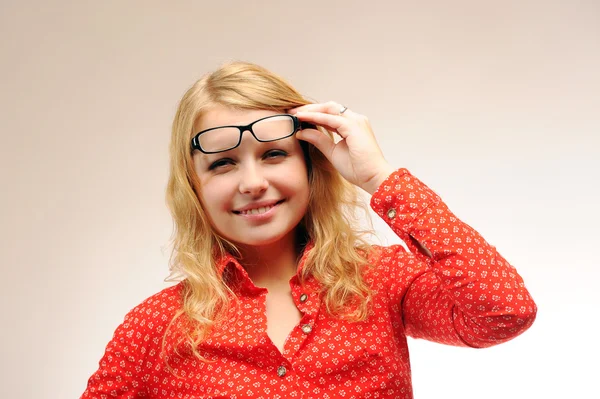 Pretty blonde girl squints in glasses — Stock Photo, Image