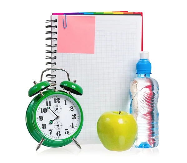 Green alarm clock, apple and bottle of water — Stock Photo, Image