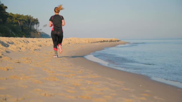 La mujer corre en la playa del mar — Vídeos de Stock