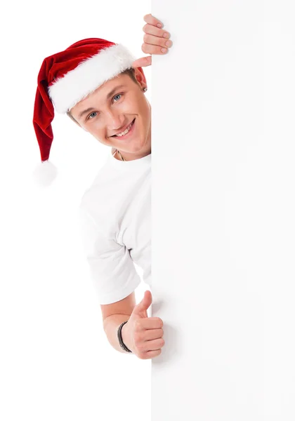 Jonge man in Kerstman hoed — Stockfoto