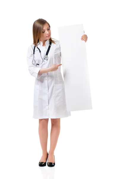 Female doctor with stethoscope showing blank — Stock Photo, Image