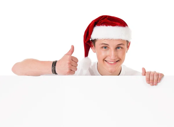 Jonge man in Kerstman hoed — Stockfoto