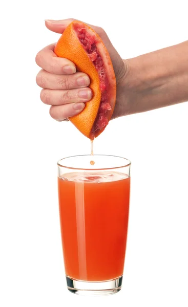 Grapefruit juice and hand — Stock Photo, Image