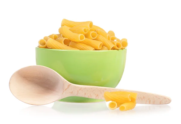 Pasta in green plate with wooden spoon — Stock Photo, Image