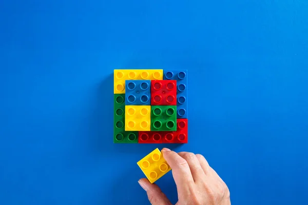 Hand Stacking Colorful Plastic Block — Stock Photo, Image