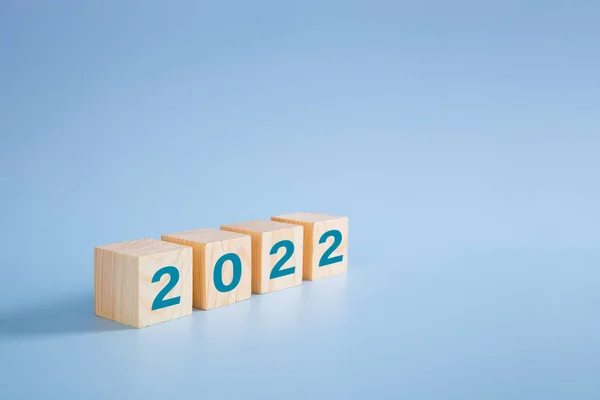 2022 number on wooden block on blue background - 2022 new year concept