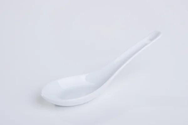White empty ceramic spoon — Stock Photo, Image