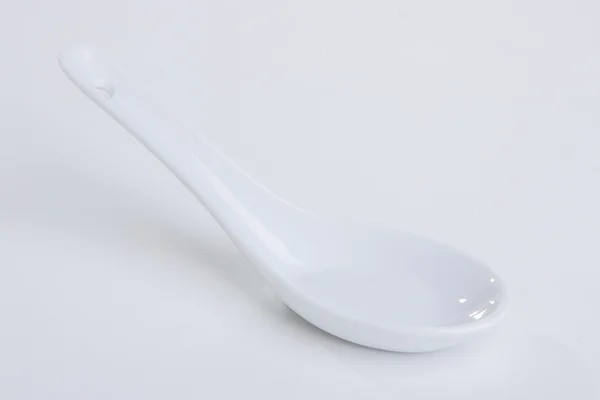 White empty ceramic spoon — Stock Photo, Image