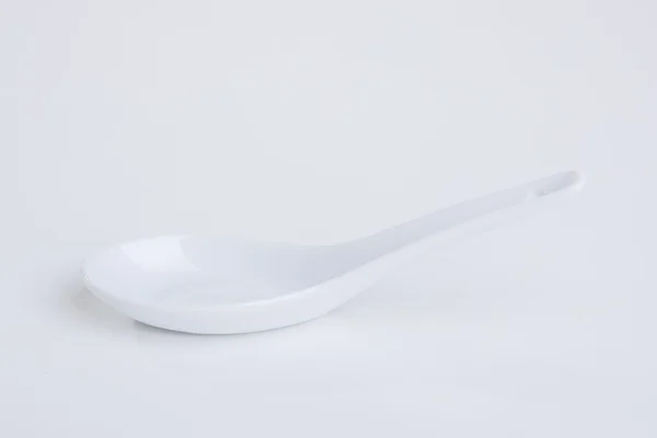 White empty ceramic spoon — Stock Photo, Image