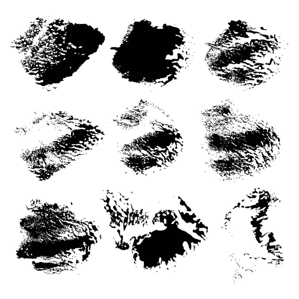 Set of abstract vector rough imprints smears black paint on a wh — Stockvector