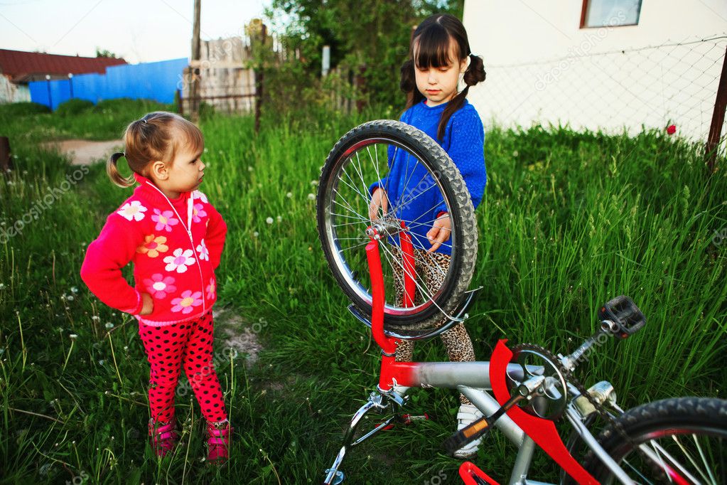 Children repair bicycle. Stock Photo by ©EdwardSV 112297588