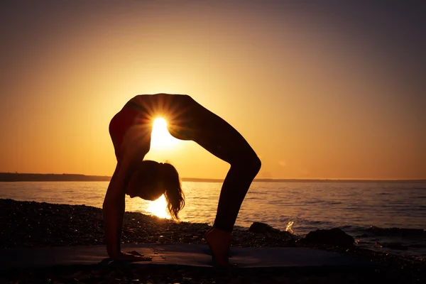 Yoga at sunrise on the beach at St Simons Island, GA Stock Photo