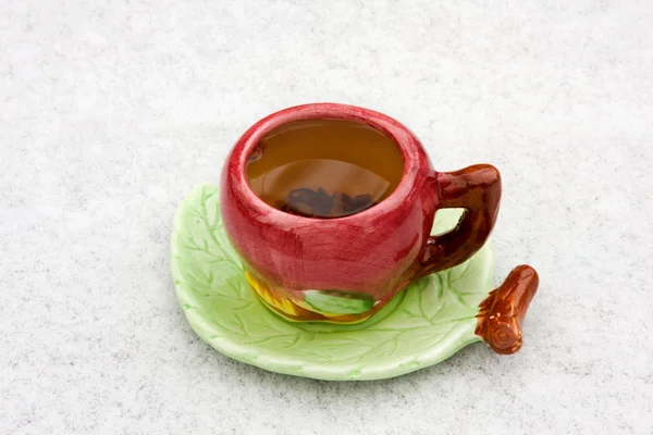 A cup of tea on a snowy background — Stock Photo, Image