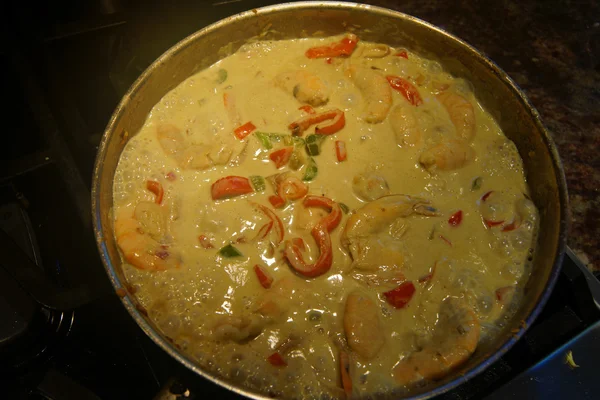 Preparing coconut shrimp curry
