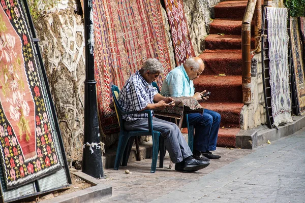 old men checking their cellphones