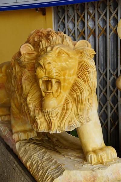 Roaring yellow lion statue
