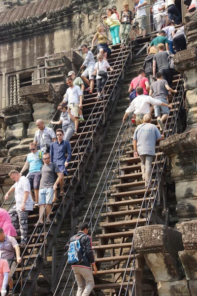 Tourists climb the steep steps