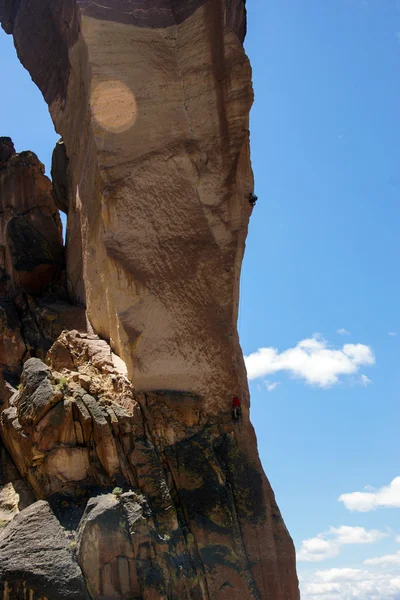 Climber  on  overhanging  cliff of Monkey Face