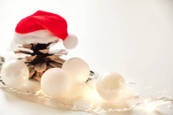 Christmas Background White Glittering Balls Garland Lights Pine Cone Santa — Stock Photo, Image