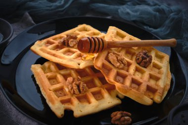 Koyu arkaplanda ballı waffle 'lar, yakın plan.