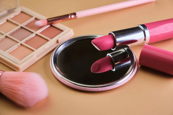 Cosmetics Makeup Lipstick Mirror Eye Shadow Brushes Beige Background — Stock Photo, Image