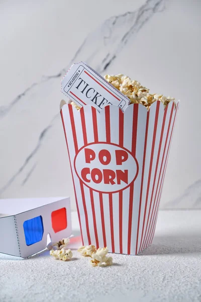 classic vintage box of popcorn, 3d glasses and cinema tickets on white background