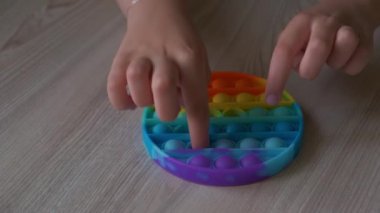 Çocuk parmaklarıyla hareketli oyuncağı yakın plan çek. Sıralama aracı, iyi motor beceriler, eğitim için terapi görevi ve beyin egzersizi.