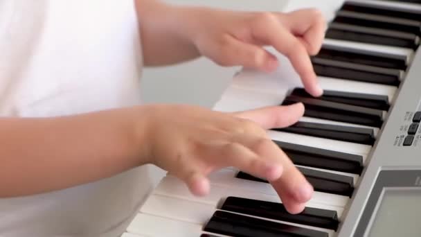 孩子弹钢琴时手指的选择性聚焦 有用于音乐会或学习音乐的乐器 弹钢琴的儿童音乐家的亲密手 图库视频片段